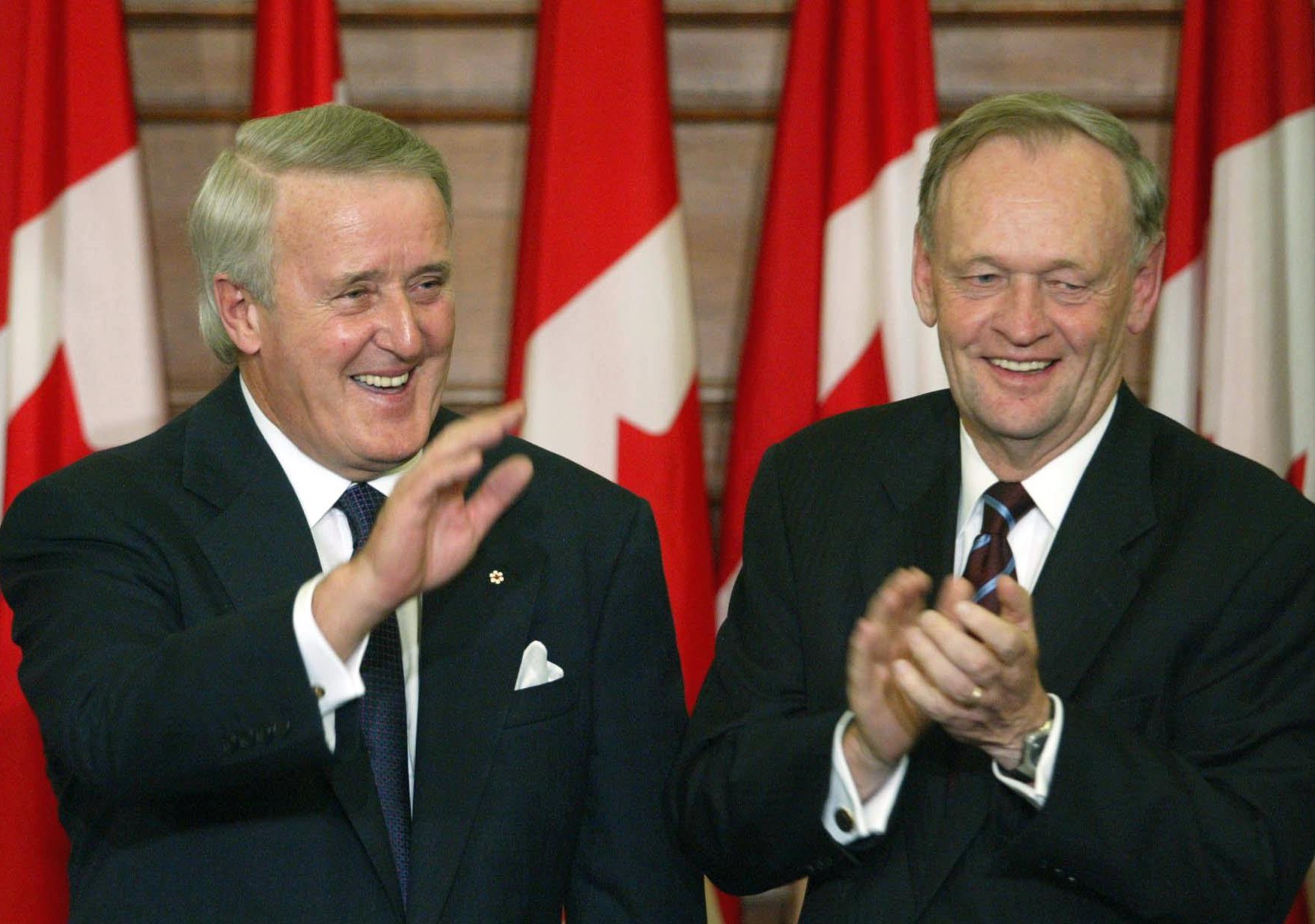 Then-prime minister Jean Chretien applauds former Prime Minister Brian Mulroney during an official unveiling ceremony of Mulroney's  official portrait.