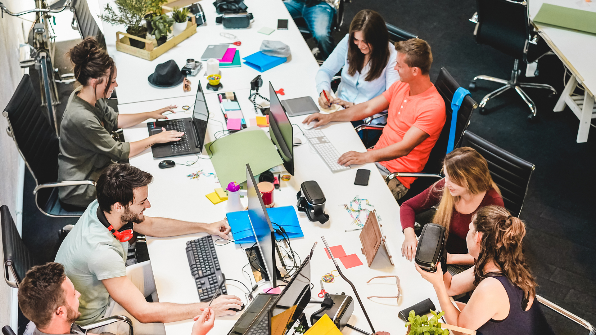 Group of people working together on laptops.