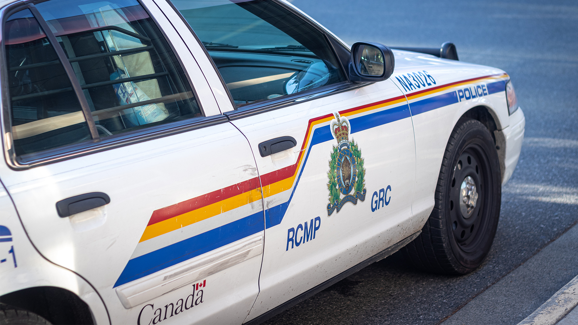 An RCMP cruiser parked on a road.