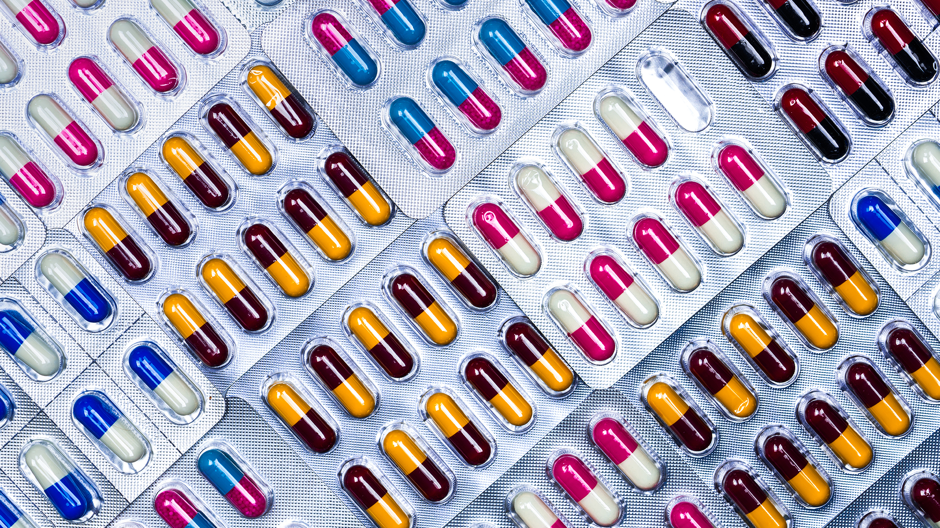 Multi-coloured capsules in bubble packs.