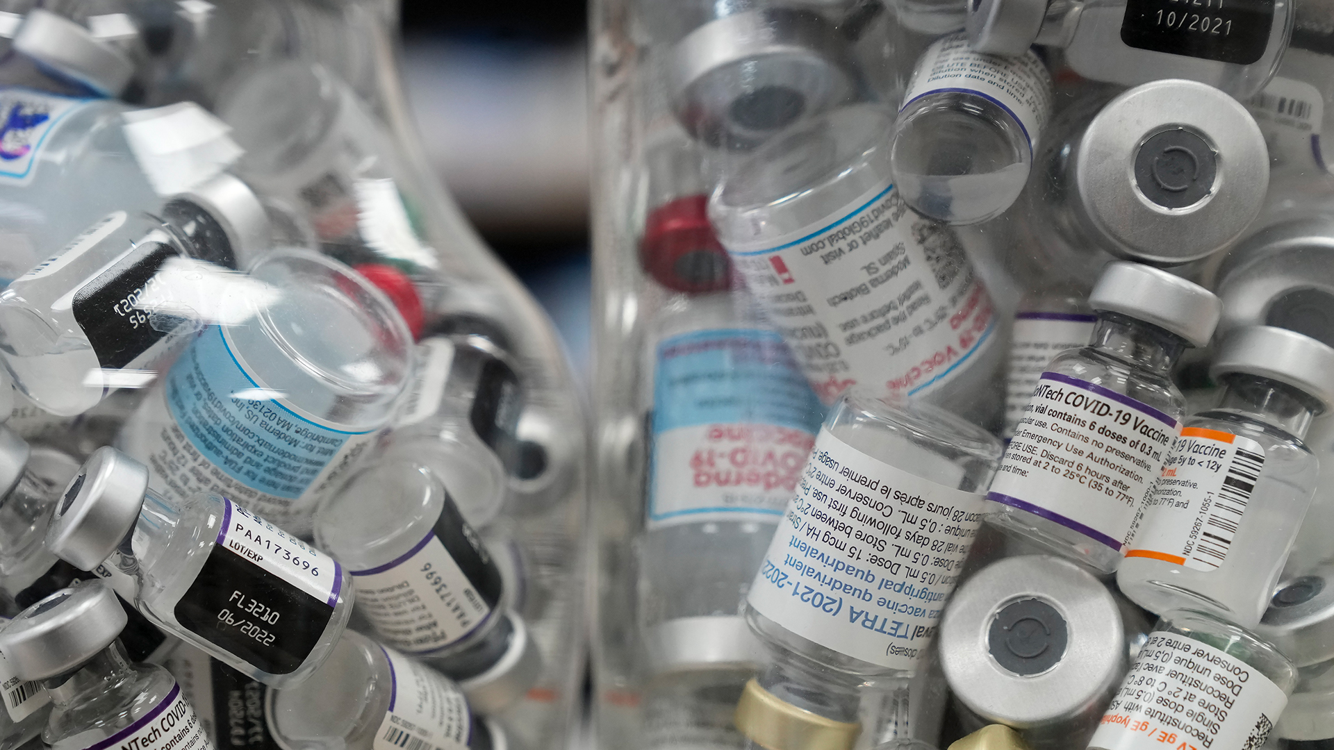 Dozens of the tiny one-dose jars are stuffed into two glass jars. 