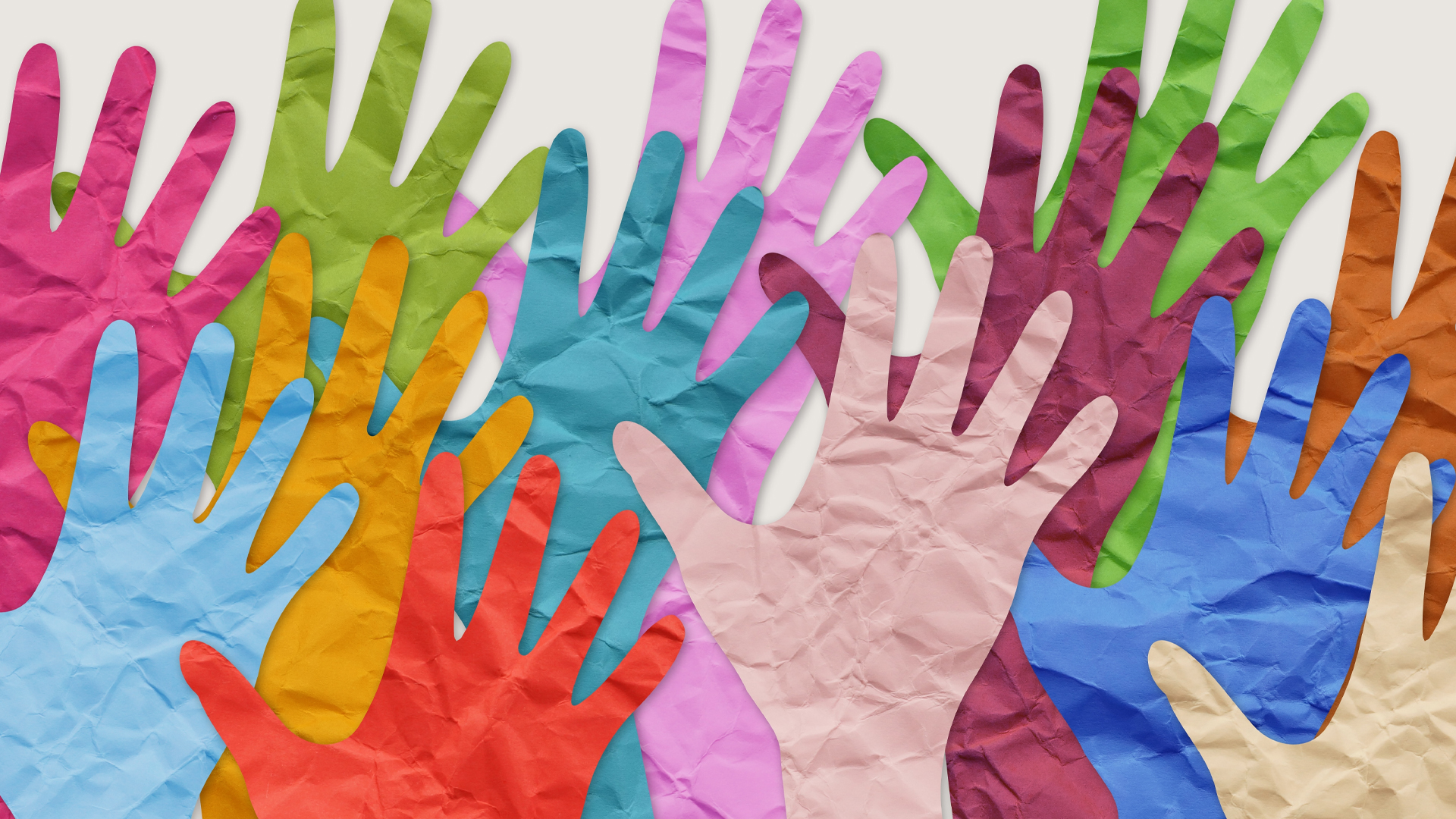 A collage of colourful paper cutouts of hands.