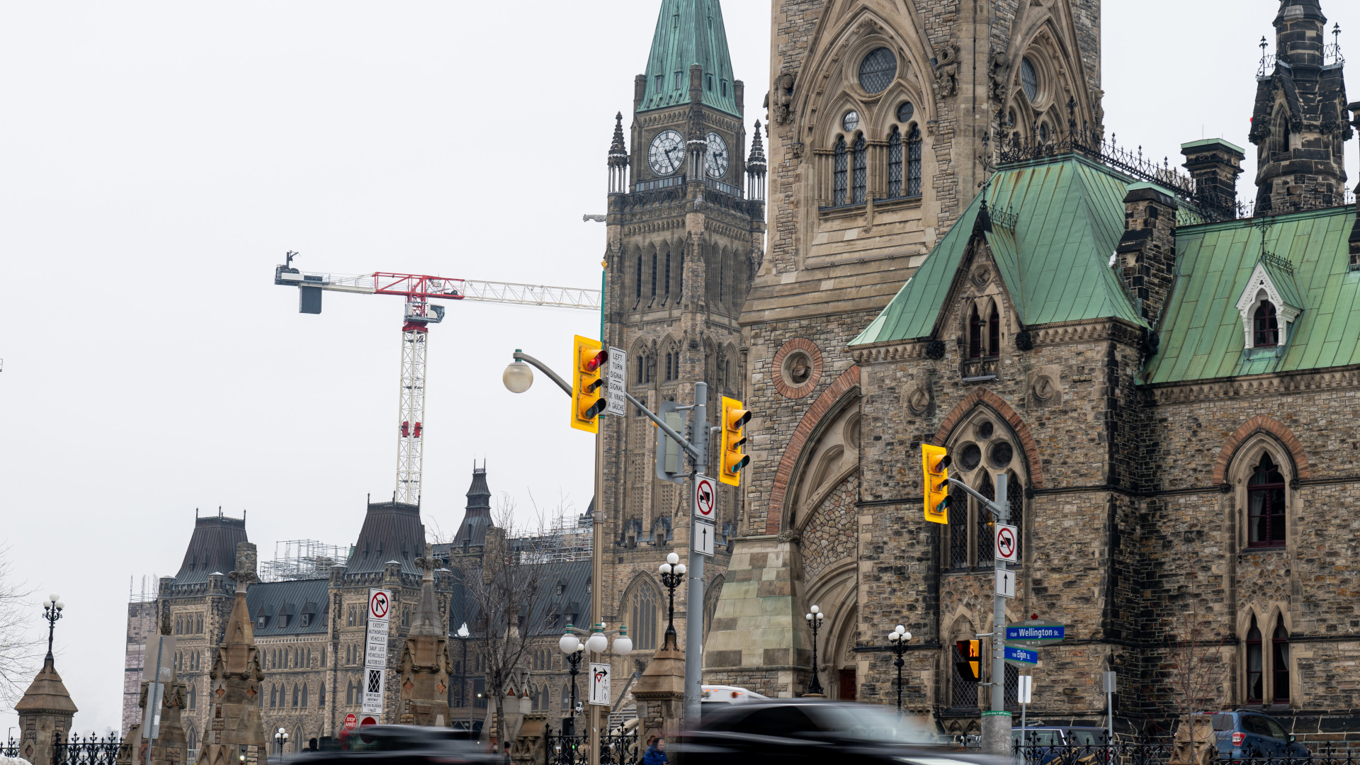 The ornate stone buildings have tall green-hued copper roofs.